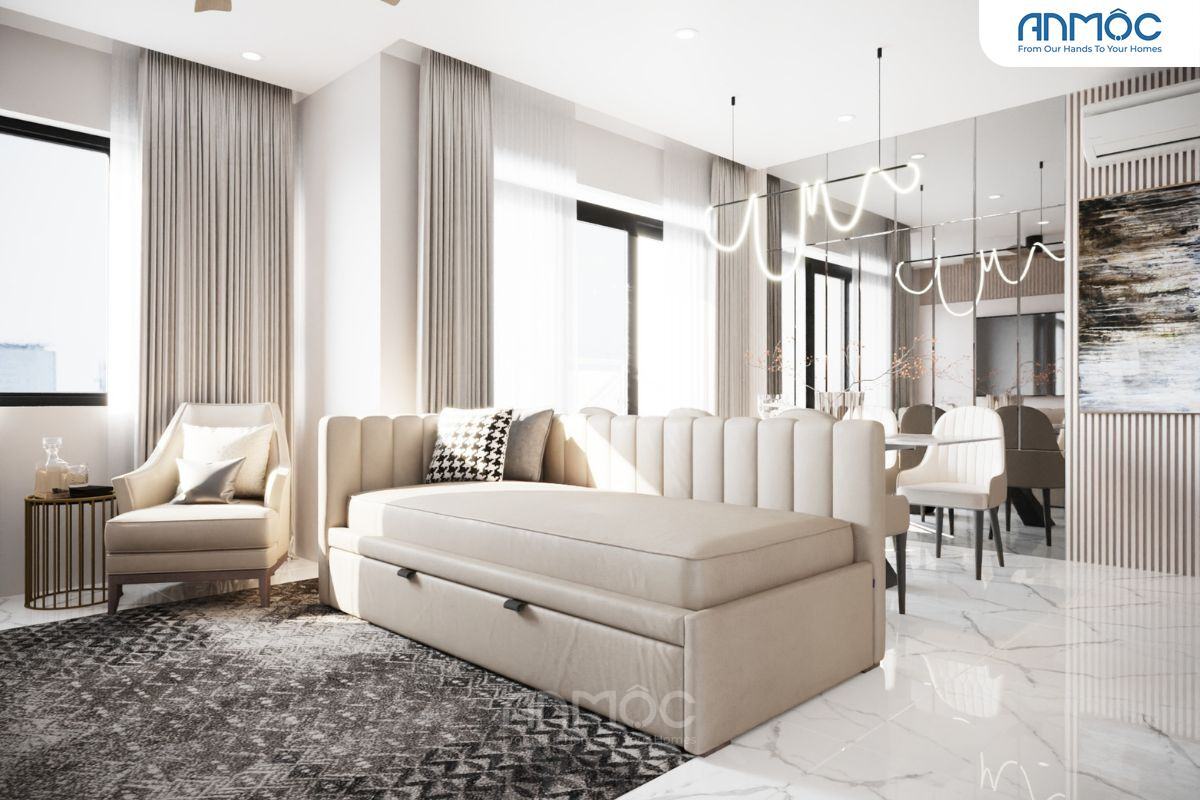 55+ Mẫu Thiết Kế Nội Thất Chung Cư "Đỉnh Nhất" 2026 2868 Góc phòng khách có sofa giường màu be, ghế đọc sách đơn, bàn trà nhỏ và thảm trải sàn họa tiết hình học, tạo không gian ấm cúng